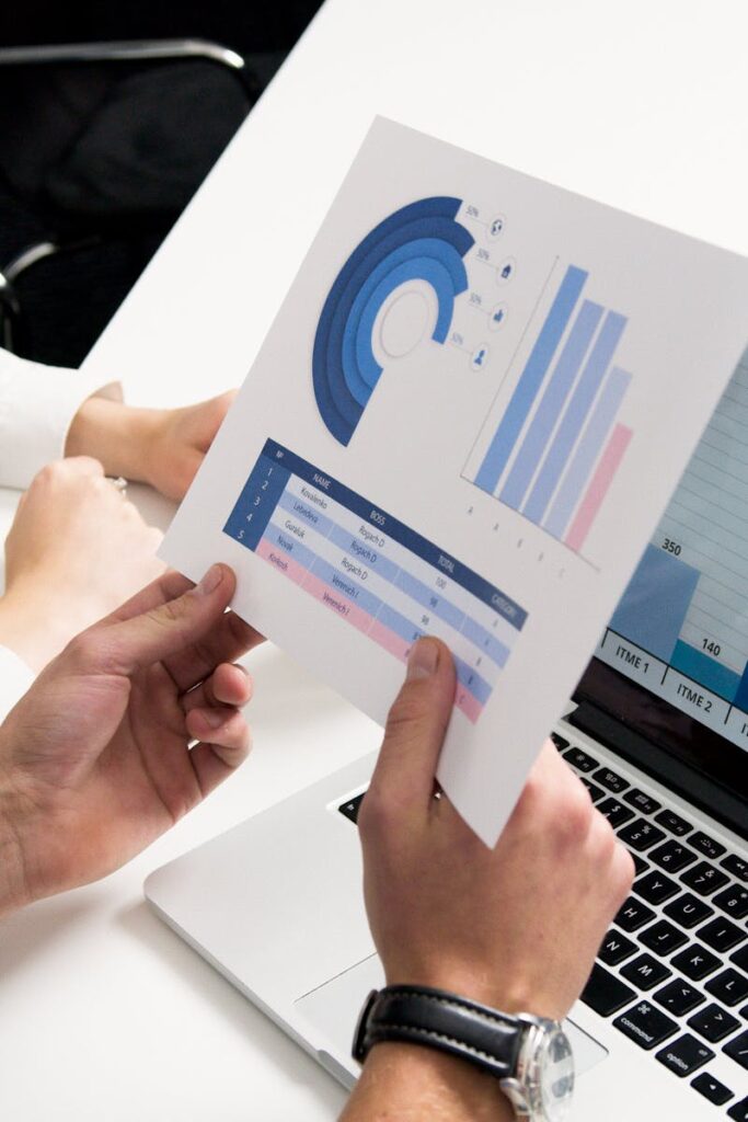 Business professionals discussing data charts and graphs in a modern office setting.
